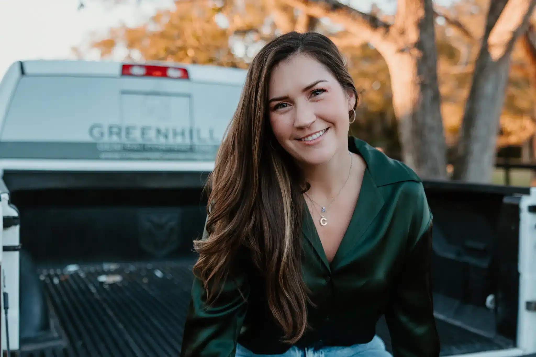 Chelsea Combs, founder of Green Hill Contracting, beside a company truck